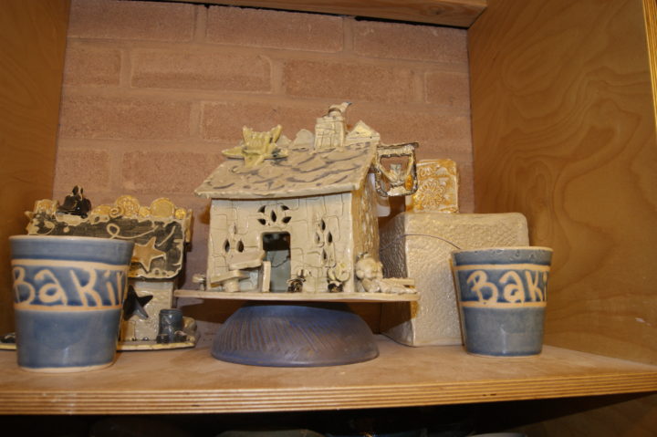 Grange Village pottery of a clay house and trinkets