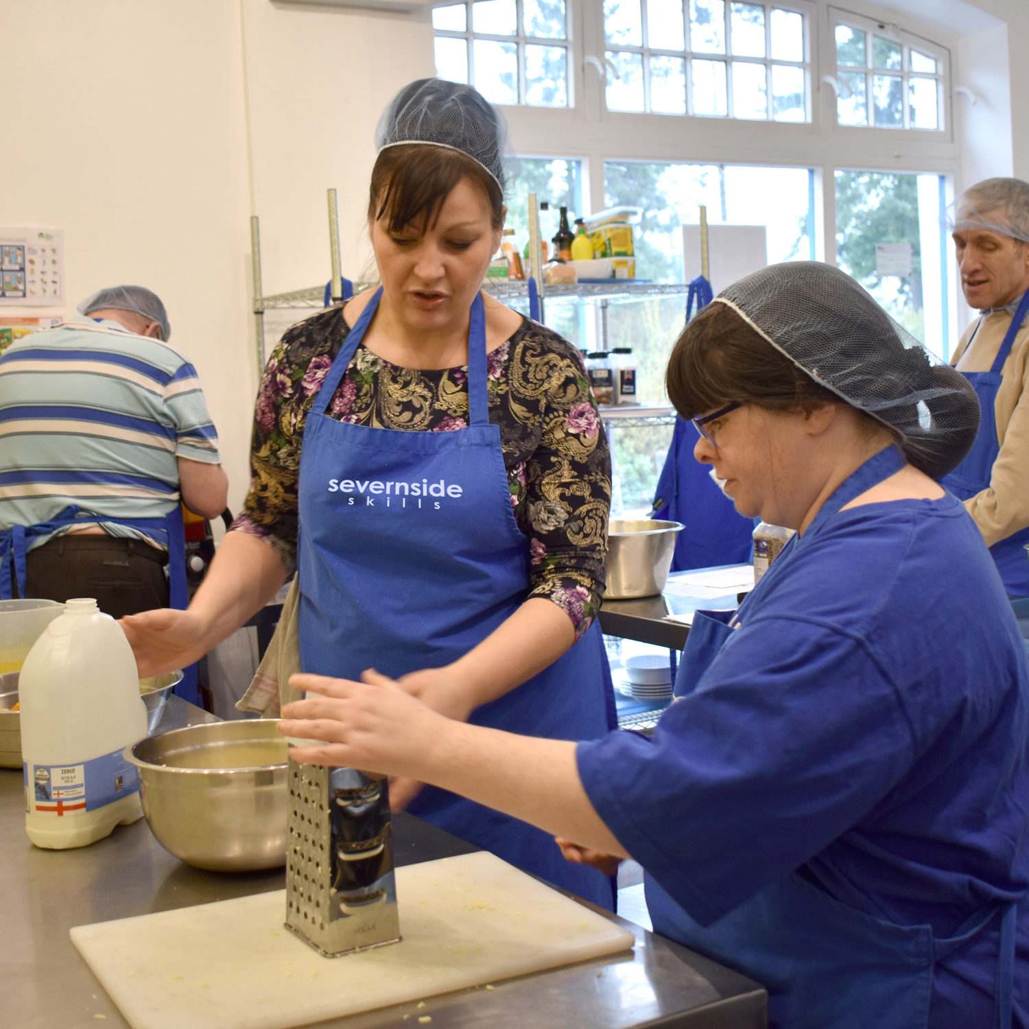 A person we support engaging in a catering course cooking in a kitchen