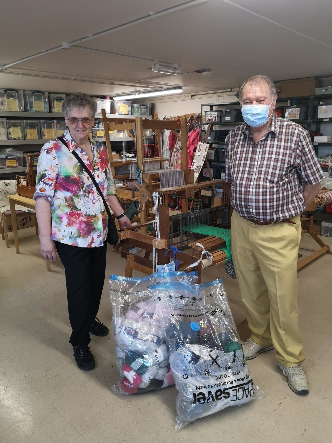 Two people we support with bags of clothes