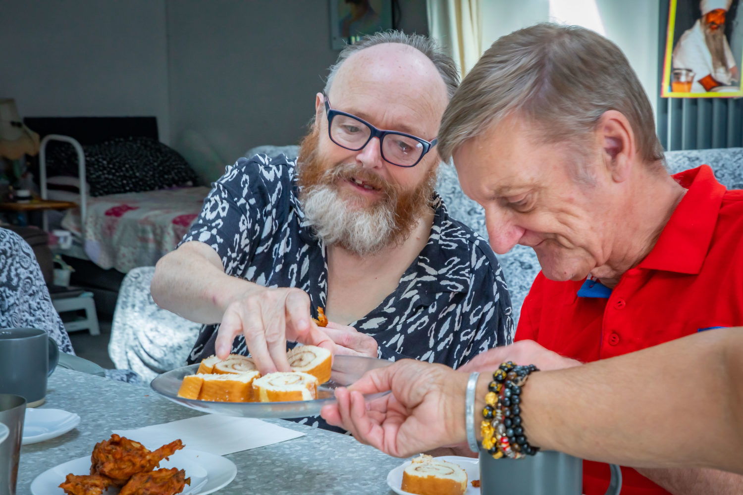 Two people we support sharing cake