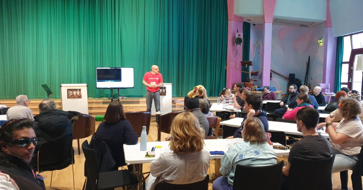 A crowd of people in a hall for an event