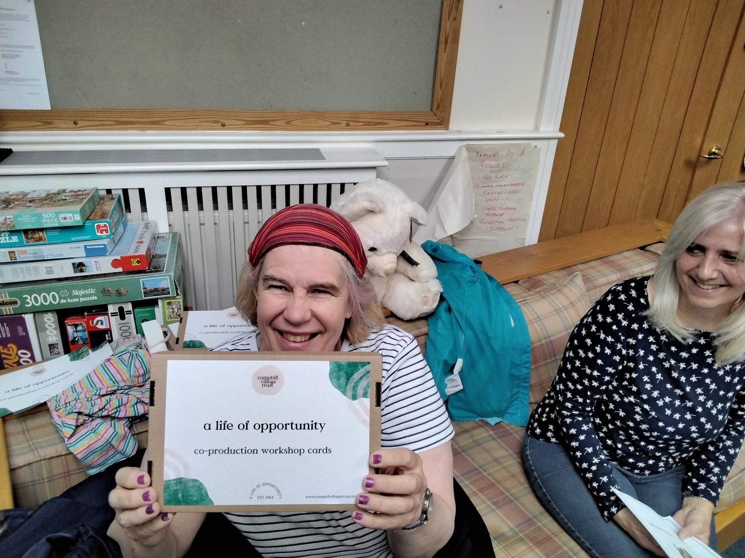 A person we support holding up a 'life of opportunity' card