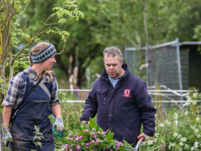 A person we support and staff member gardening