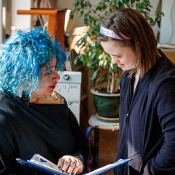 A staff member reading with a person we support