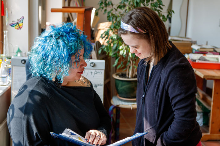 A staff member reading with a person we support