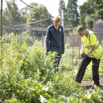 Two people we support gardening