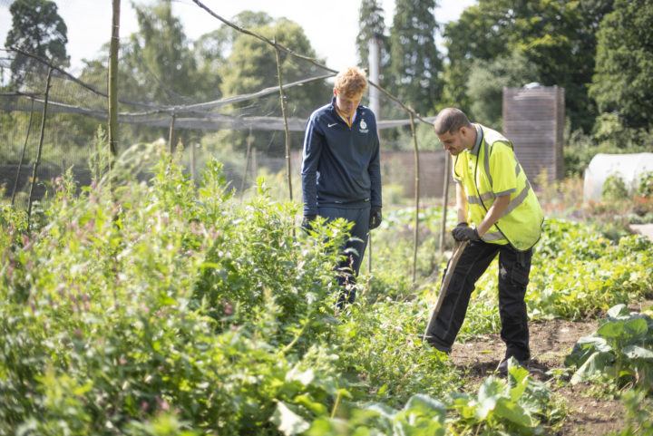 Two people we support gardening