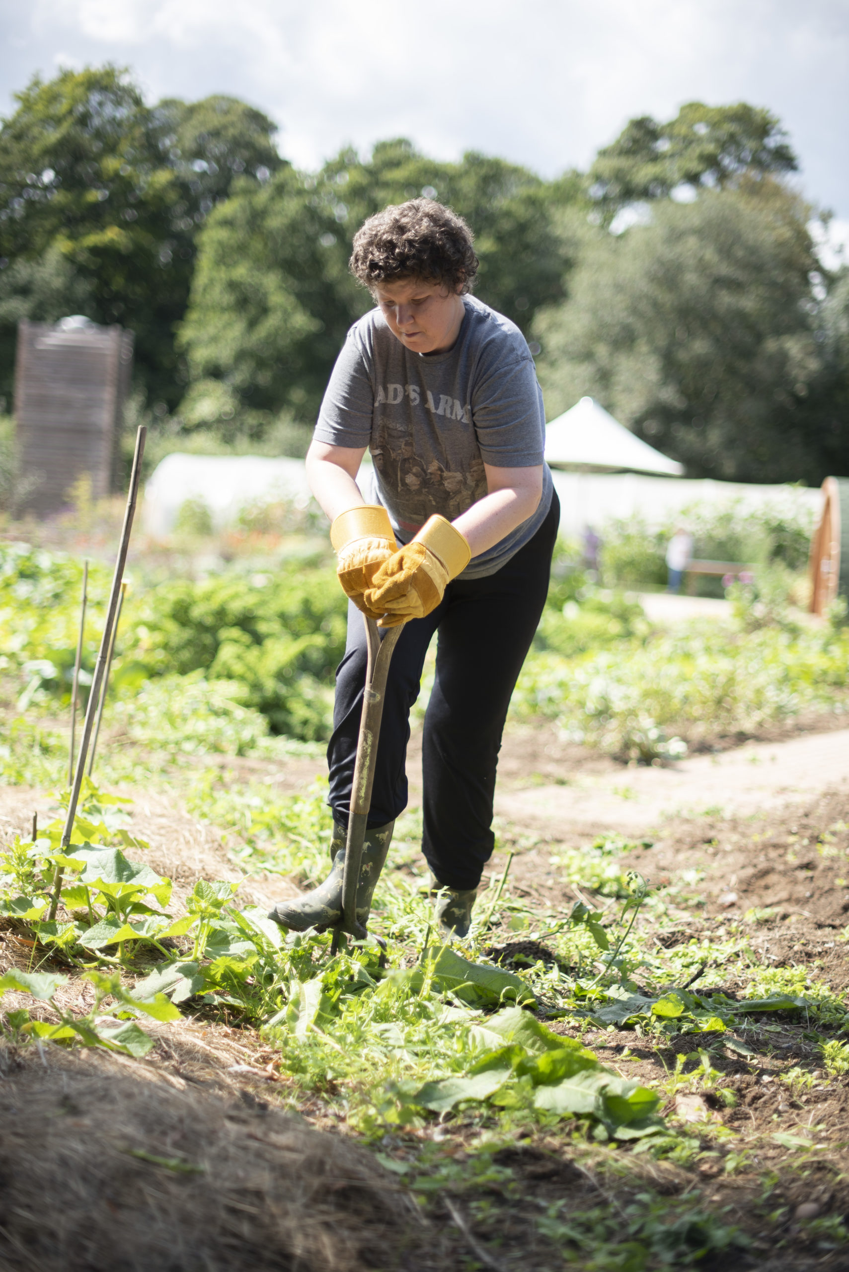 One of the people we support digging with a spade outside