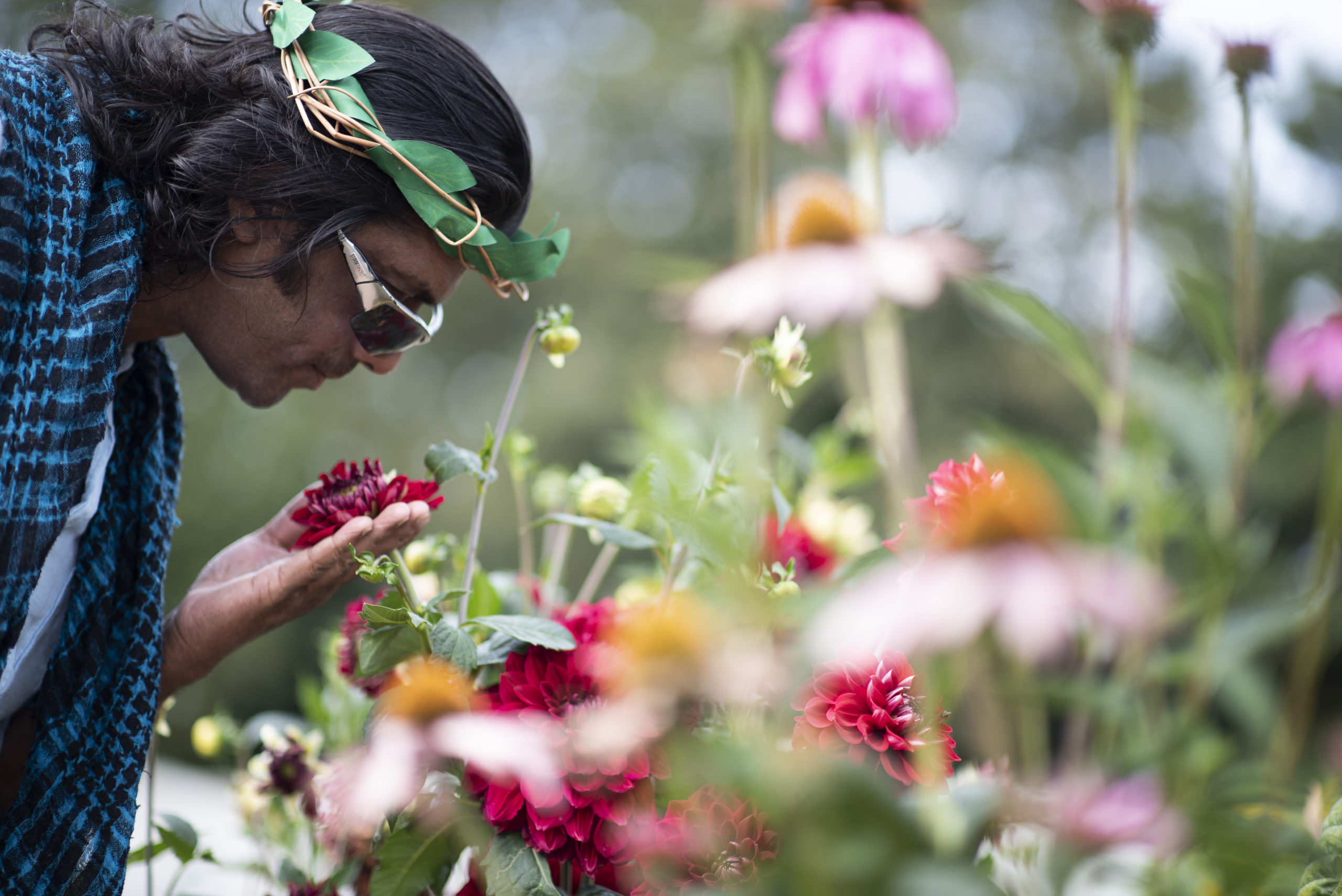 One of the people we support smelling a pink flower