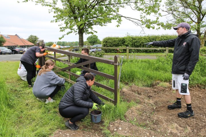 Volunteers in one of our communities painting a fence outside