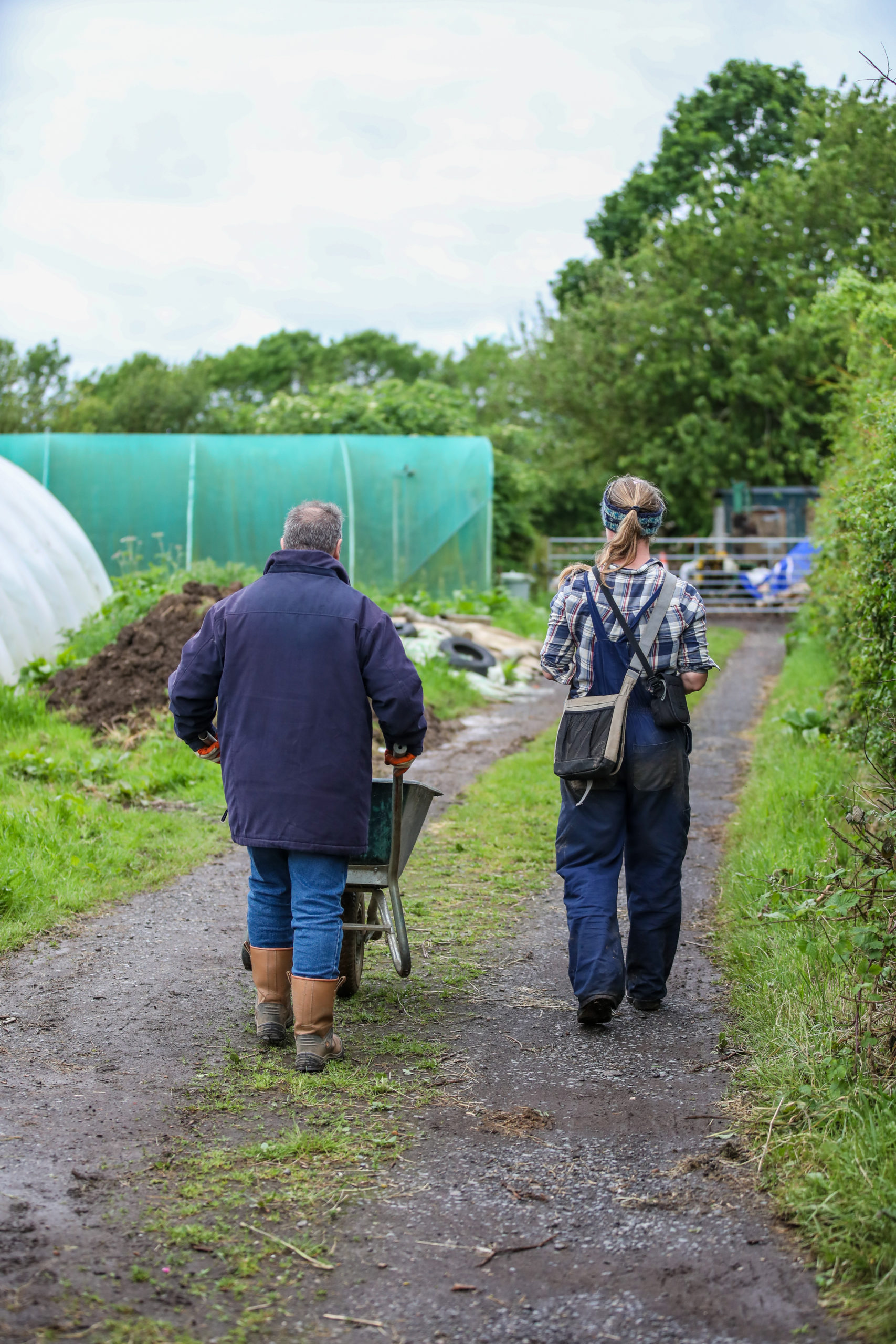 One of the people we support and staff member gardening outside in our day activities 