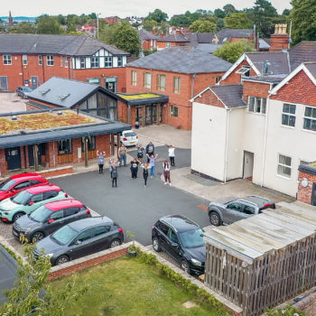 An aerial shot of our Stourbridge community with staff and people we support waving and smiling