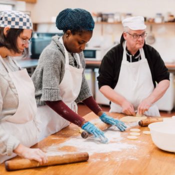 3 people cooking in a kitchen