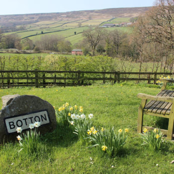 Botton village sign on a rock