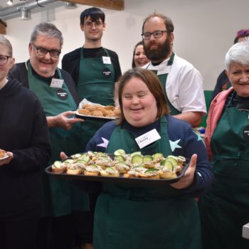 People we support in a catering workshop holding food