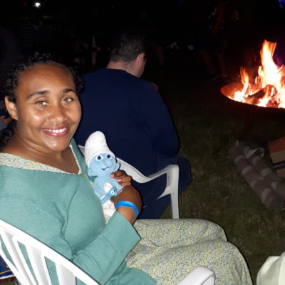 A person we support sitting by the fire