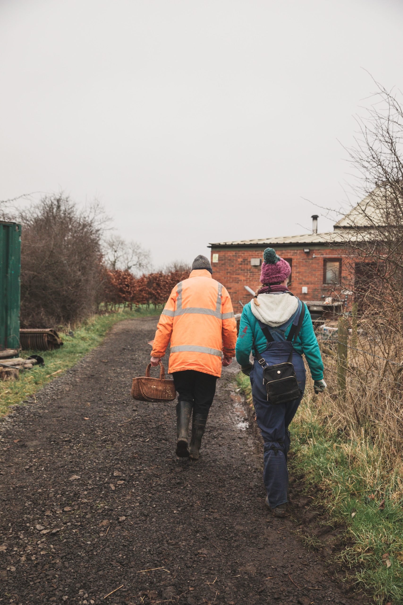 A person we support and staff member walking in the farm