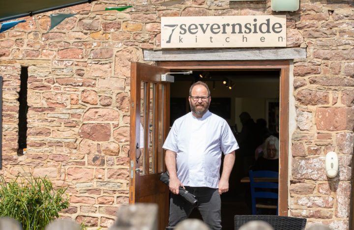 A person we support standing outside a cafe