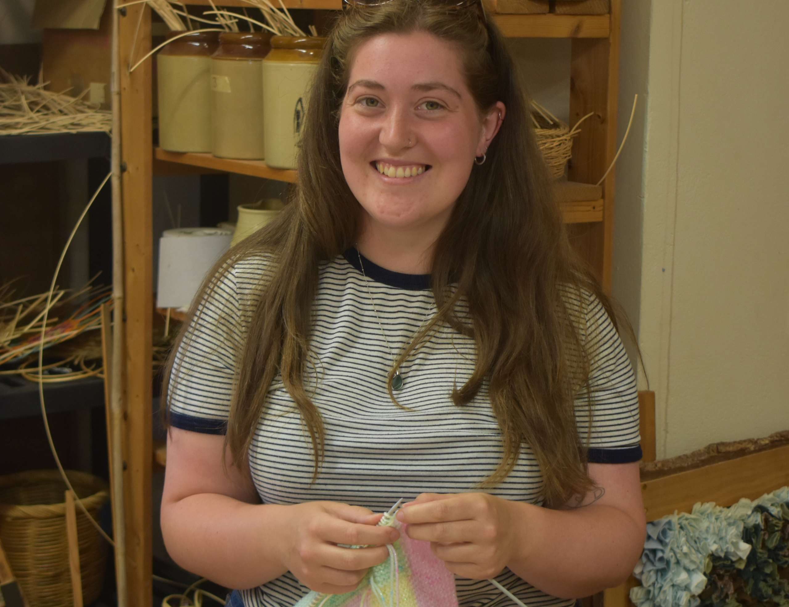 A staff member weaving in a workshop