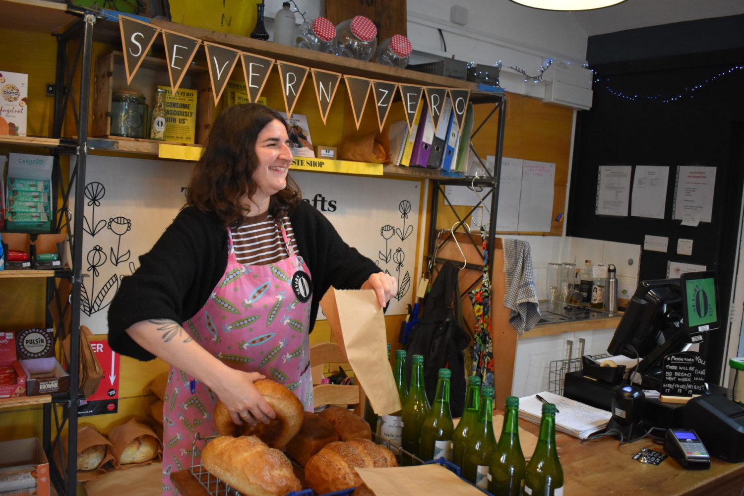 One of our staff members working in the bakery holding bread