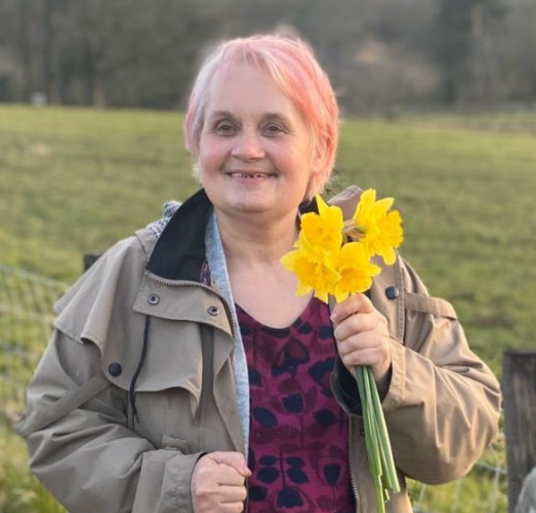 A lady holding daffodils