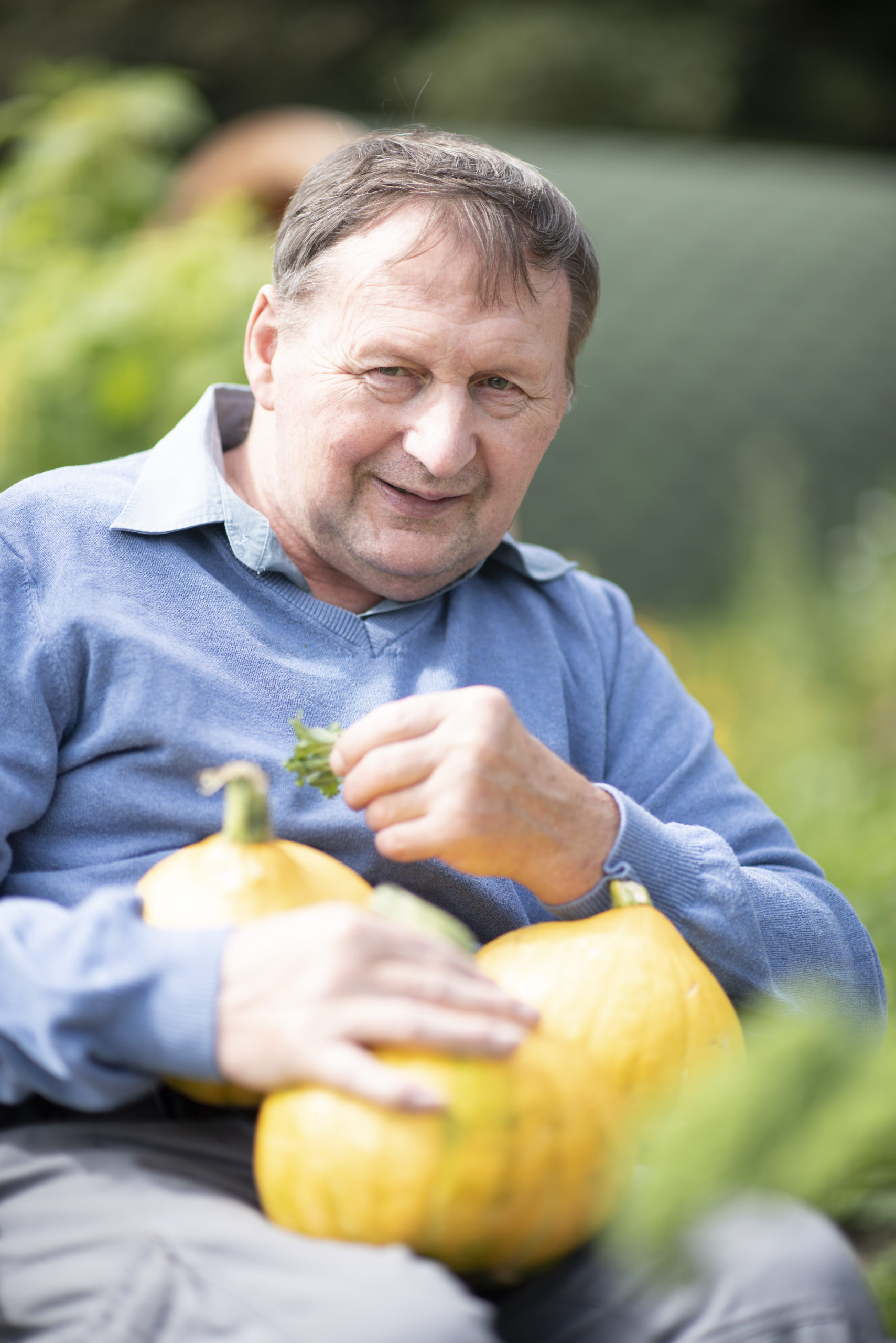 A person holding pumpkins