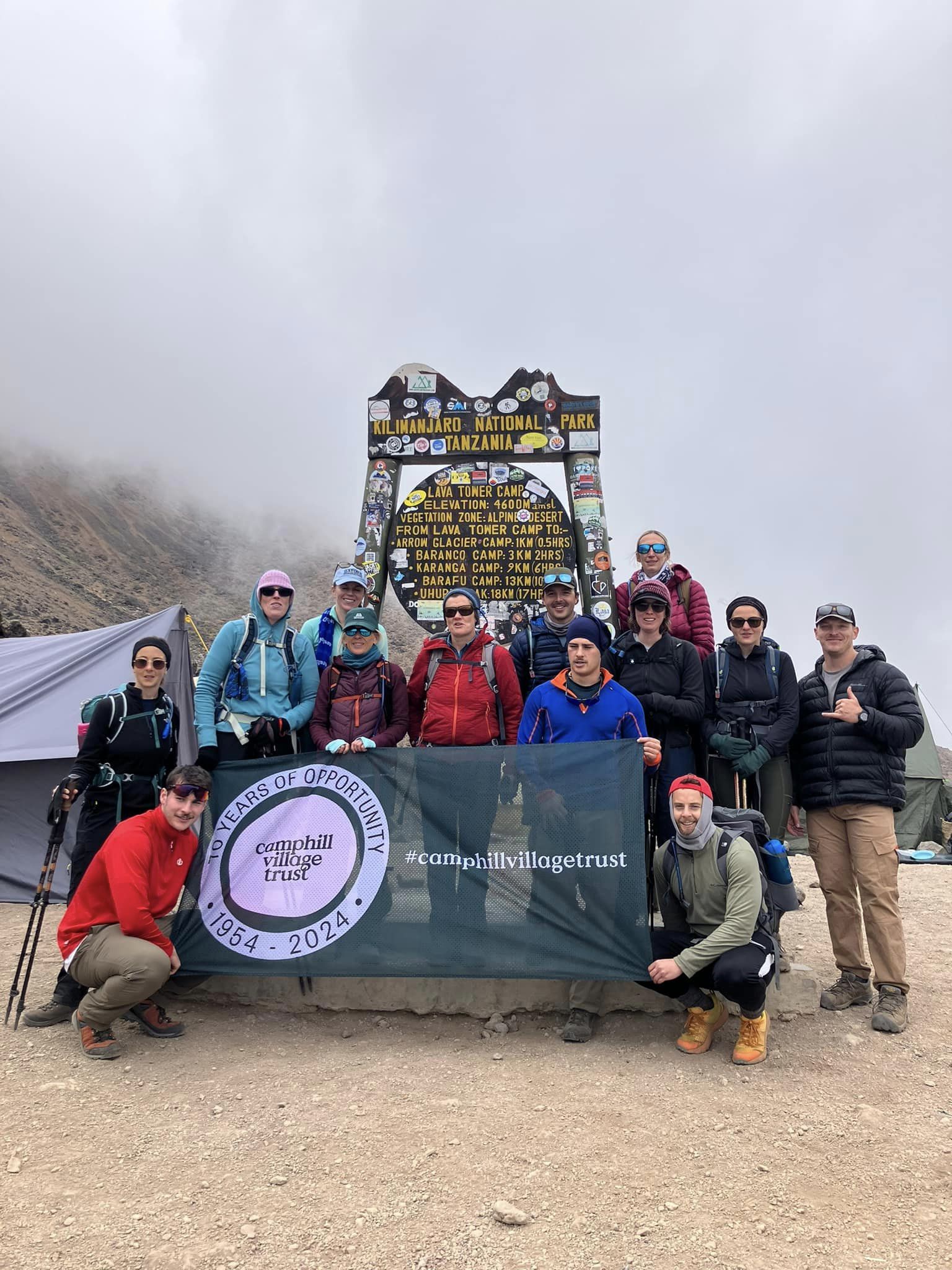 Our team holding the Trust flag on Kilimanjaro