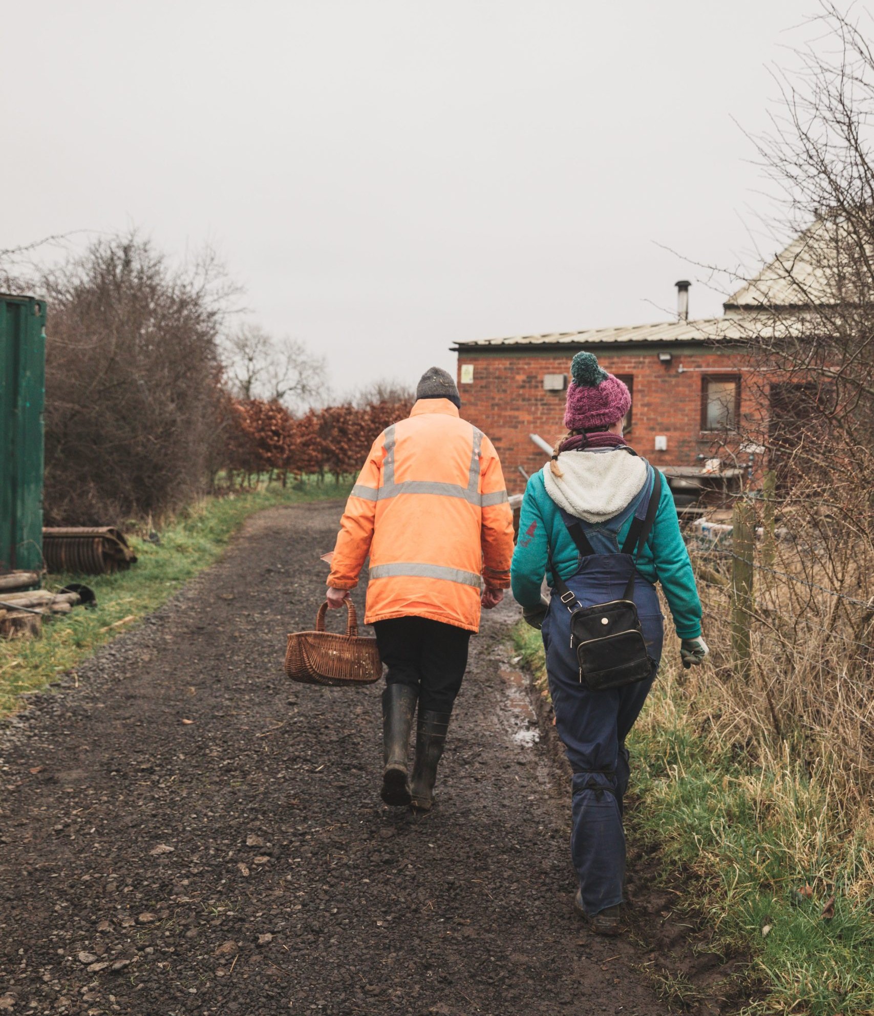 A person we support and staff member walking in the farm