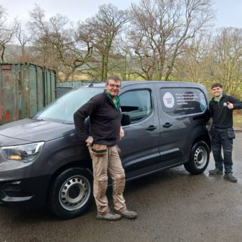 Two PALS members with electric van