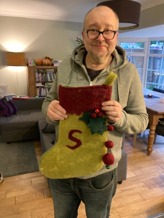 Trevor from Camphill Village Trust Shared Lives holding a stocking