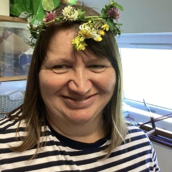 Community members in a craft workshop making flower headbands in Larchfield